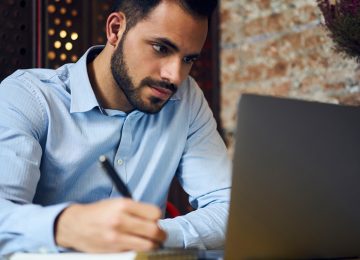 Image of young man working on laptop