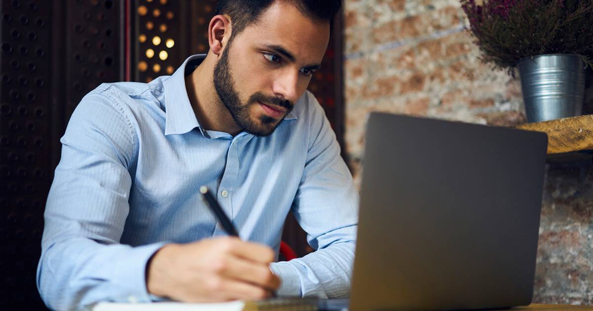 Image of young man working on laptop