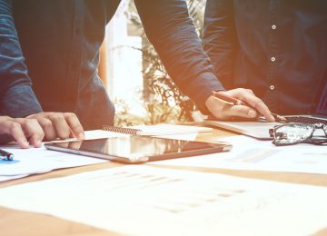 Image of people looking over documents in office discussing external transfer