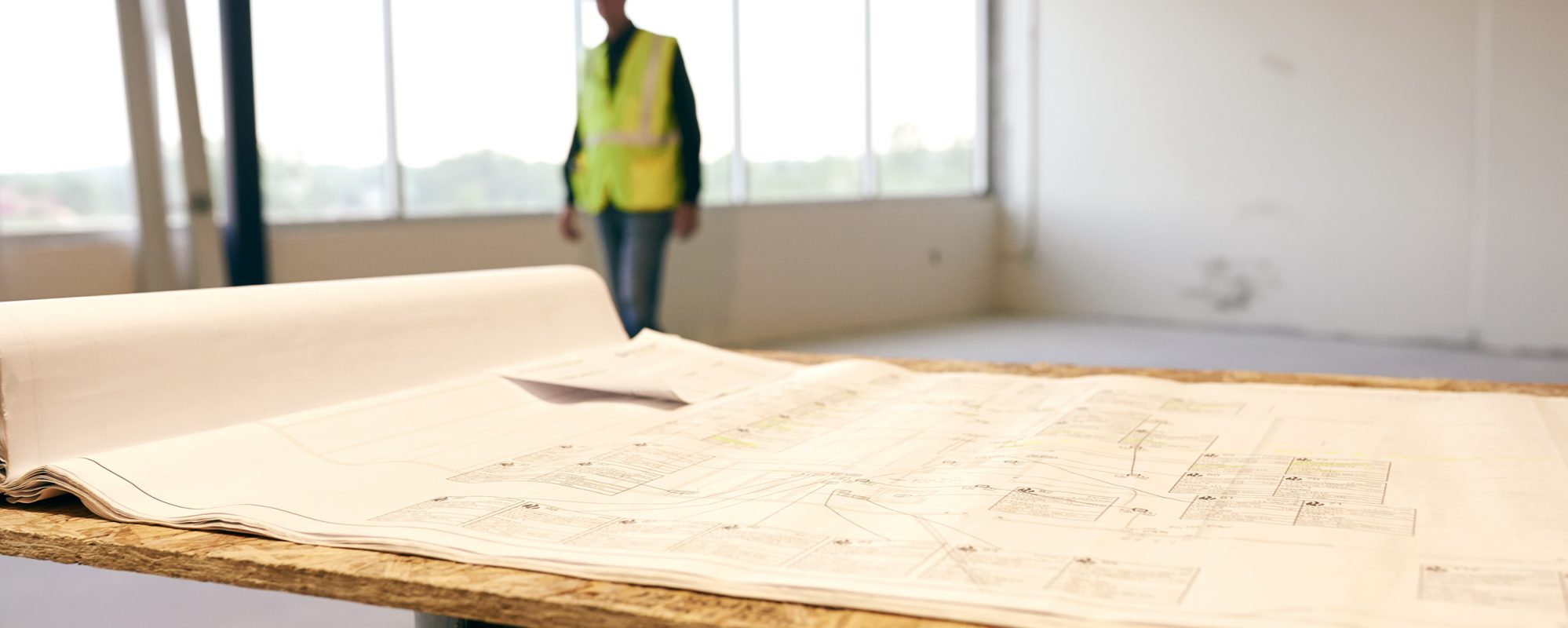 Image of construction plans and construction worker in background on Beene Garter's state and local tax page