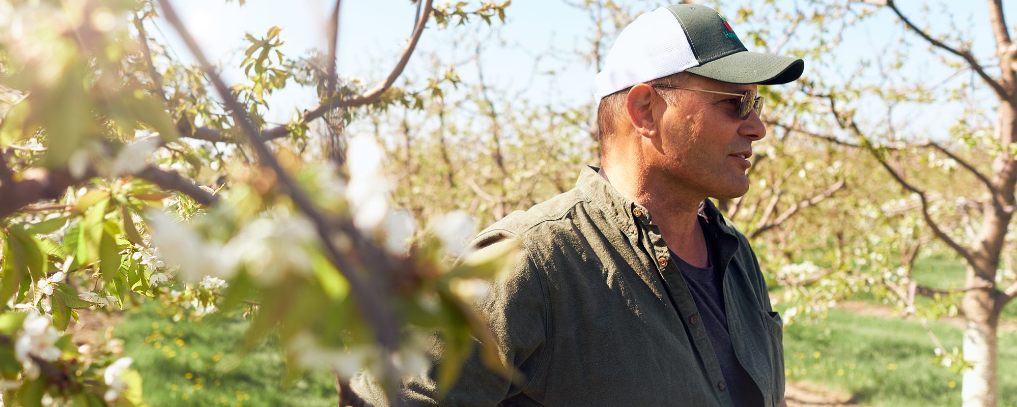 Image of farmer in apple orchard on Beene Garter's succession planning page