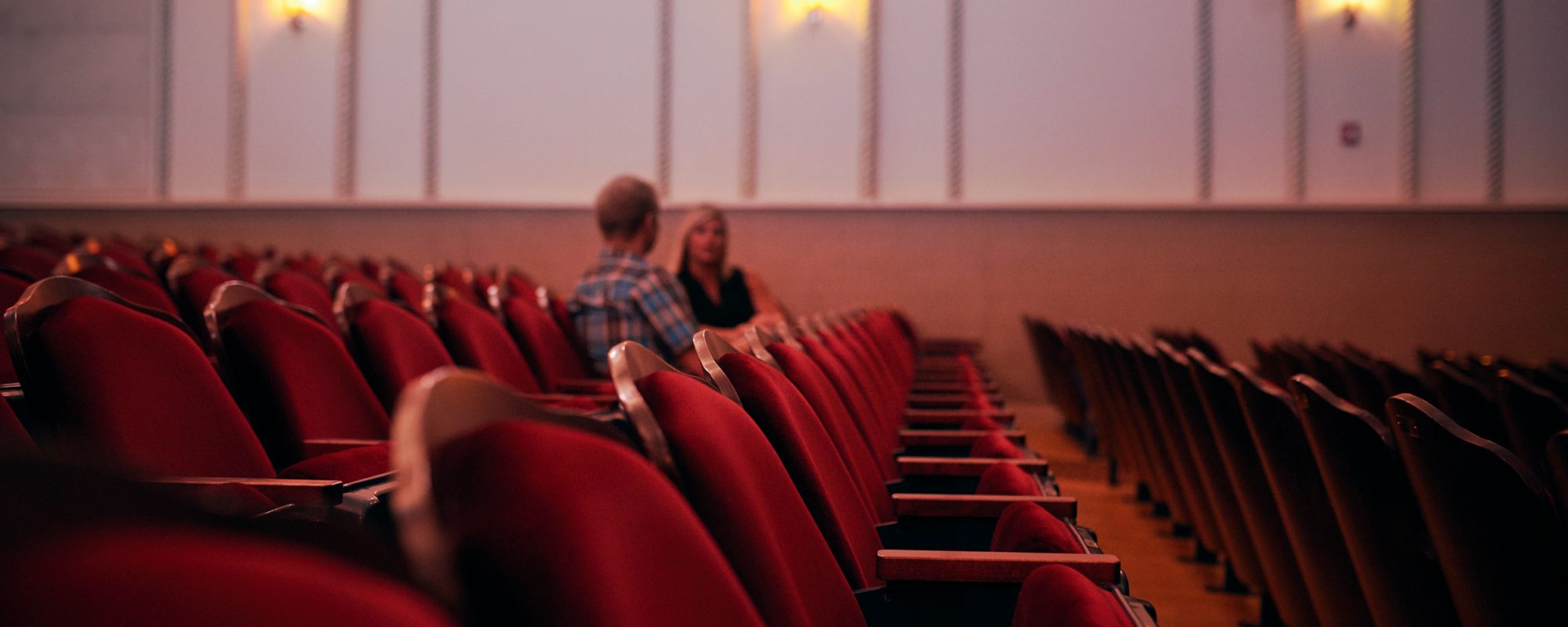 Image of two moviegoers talking in theater on Beene Garter's nonprofit tax page