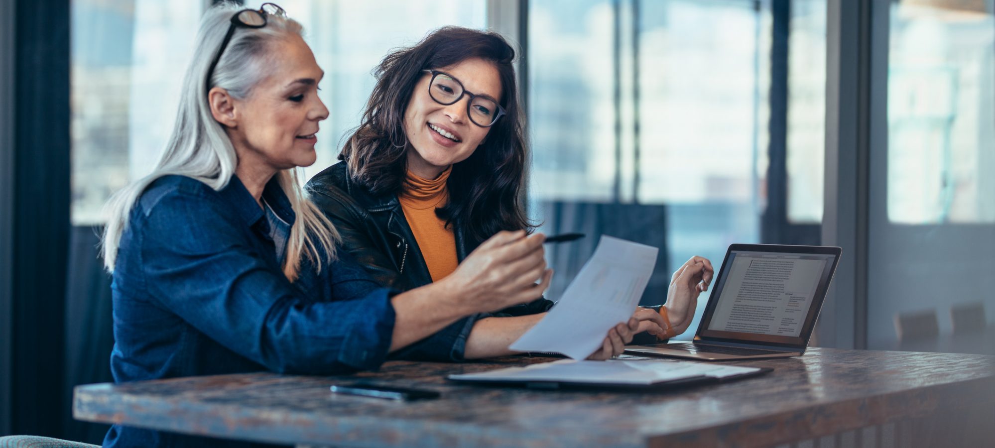 Image of two women analyzing documents about valuation discount regulations and estate plan