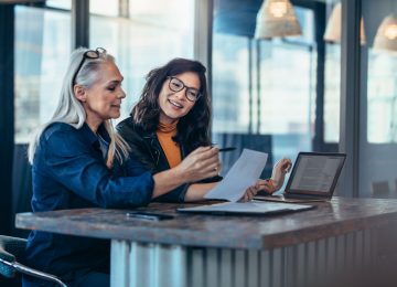 Image of two women analyzing documents about valuation discount regulations and estate plan