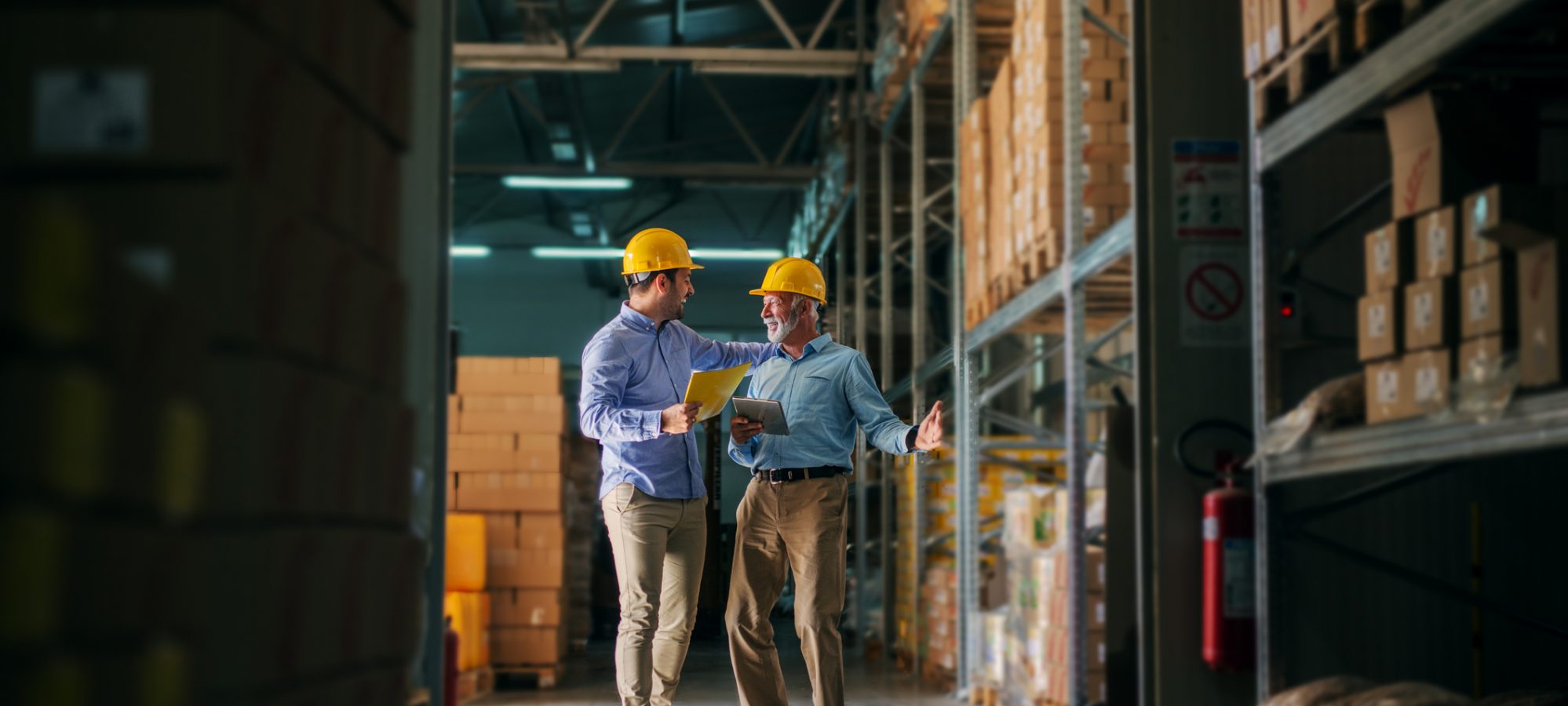 Image of two men standing in warehouse and valuing inventory