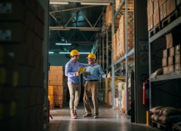 Image of two men standing in warehouse and valuing inventory