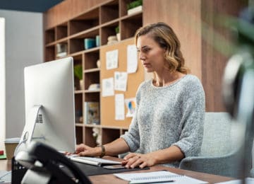 Business woman using computer to submit income information to Florida's department of revenue