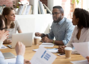 Group of 4 nonprofit members discussing their org's issues