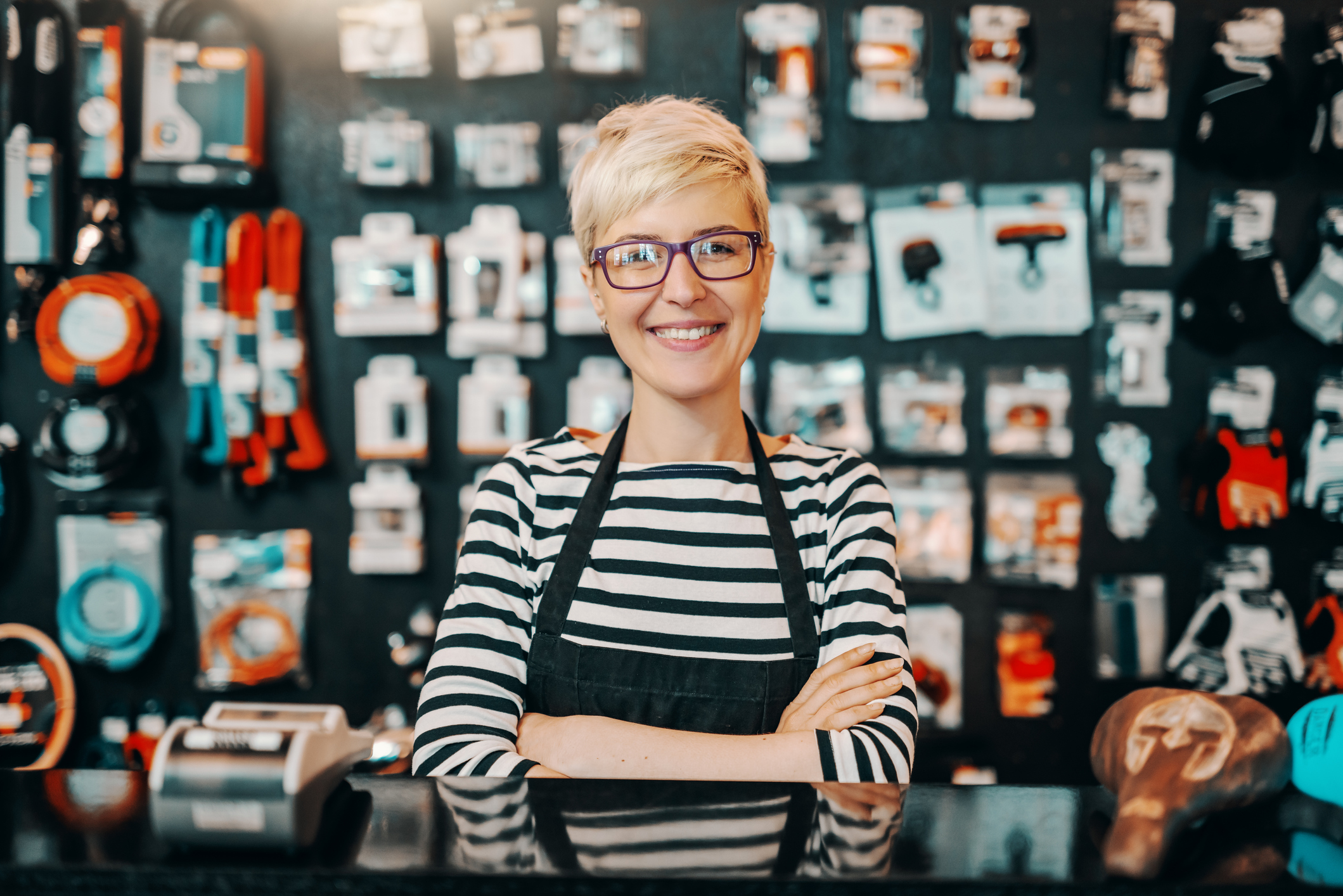 woman poses smiling in her store