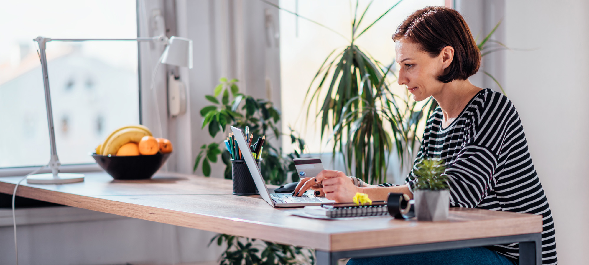 a woman online shops at home after reviewing her state's new sales tax nexus after wayfair