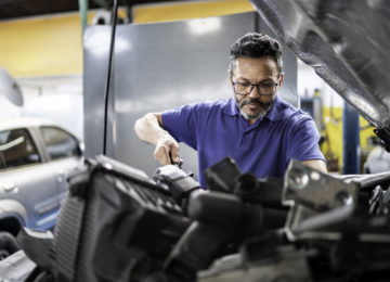 Man repairing a car in auto repair shop