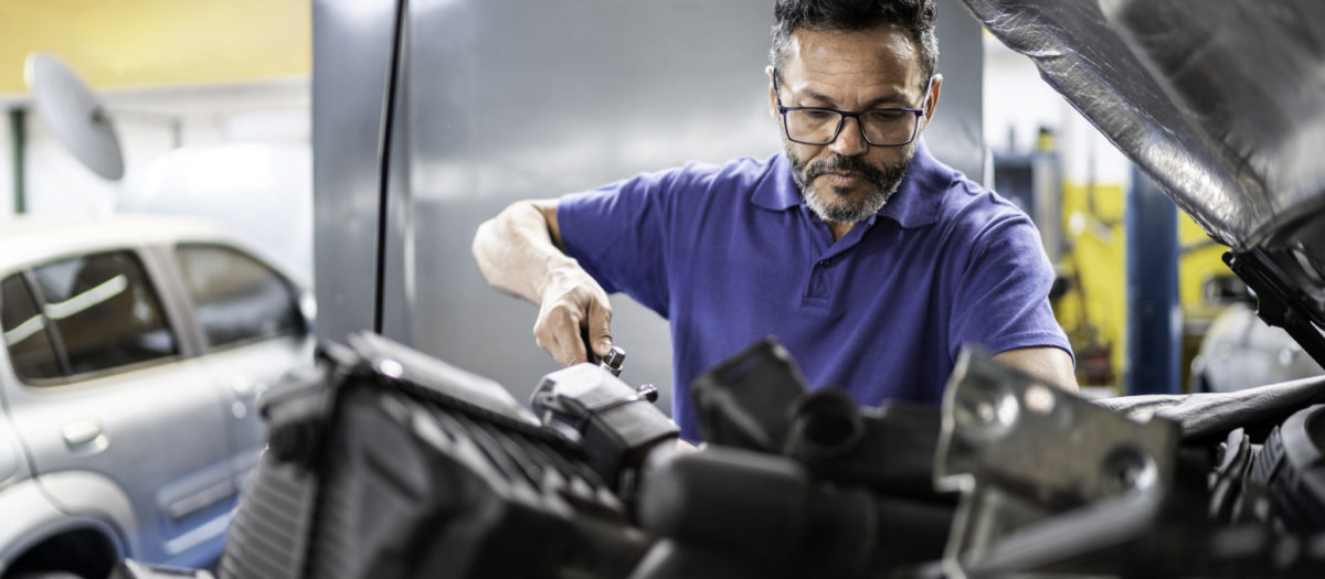 Man repairing a car in auto repair shop