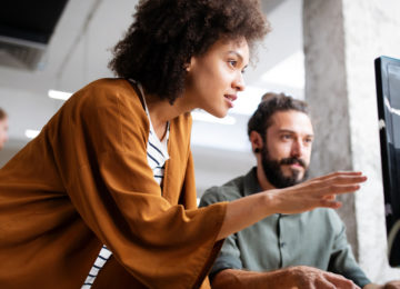 a woman discusses delay of payroll tax with a man