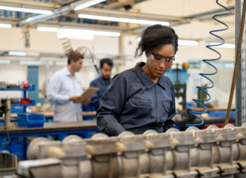 A young woman working at a factory that is considering switching payroll companies