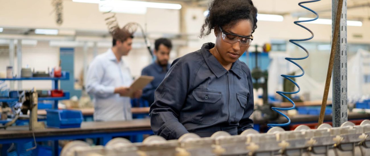 A young woman working at a factory that is considering switching payroll companies