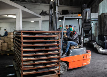 Forklift driver wearing PPE in a warehouse - qualifies for industrial processing exemption