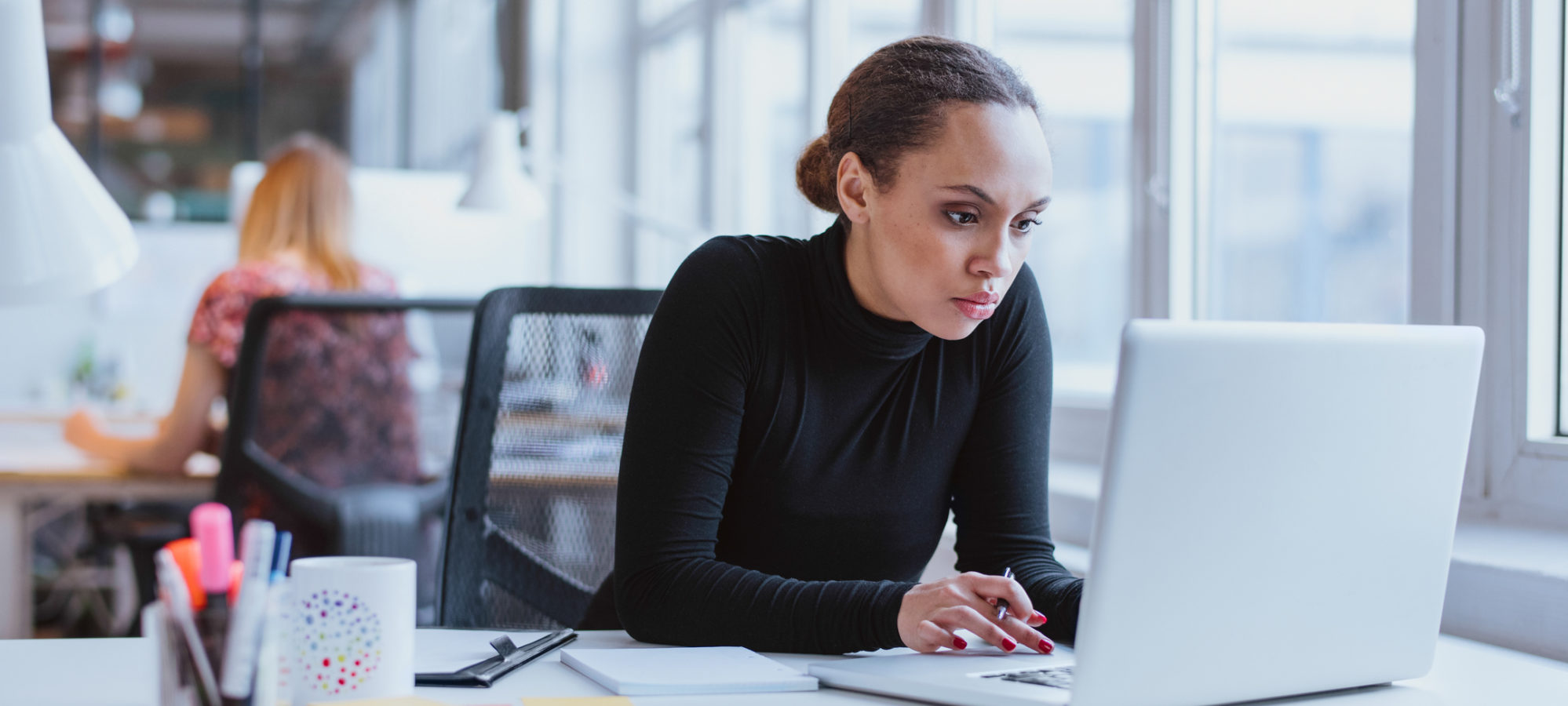 Young business woman compiling data for new EEO-1 reporting requirement