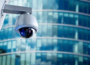 Security camera mounted on office building to detect fraud