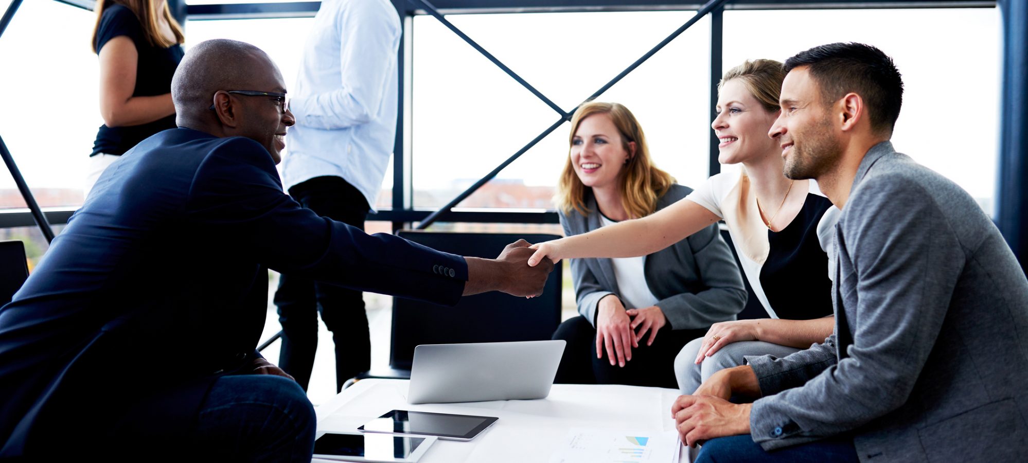 Image of male executive sitting and meeting with his M&A team