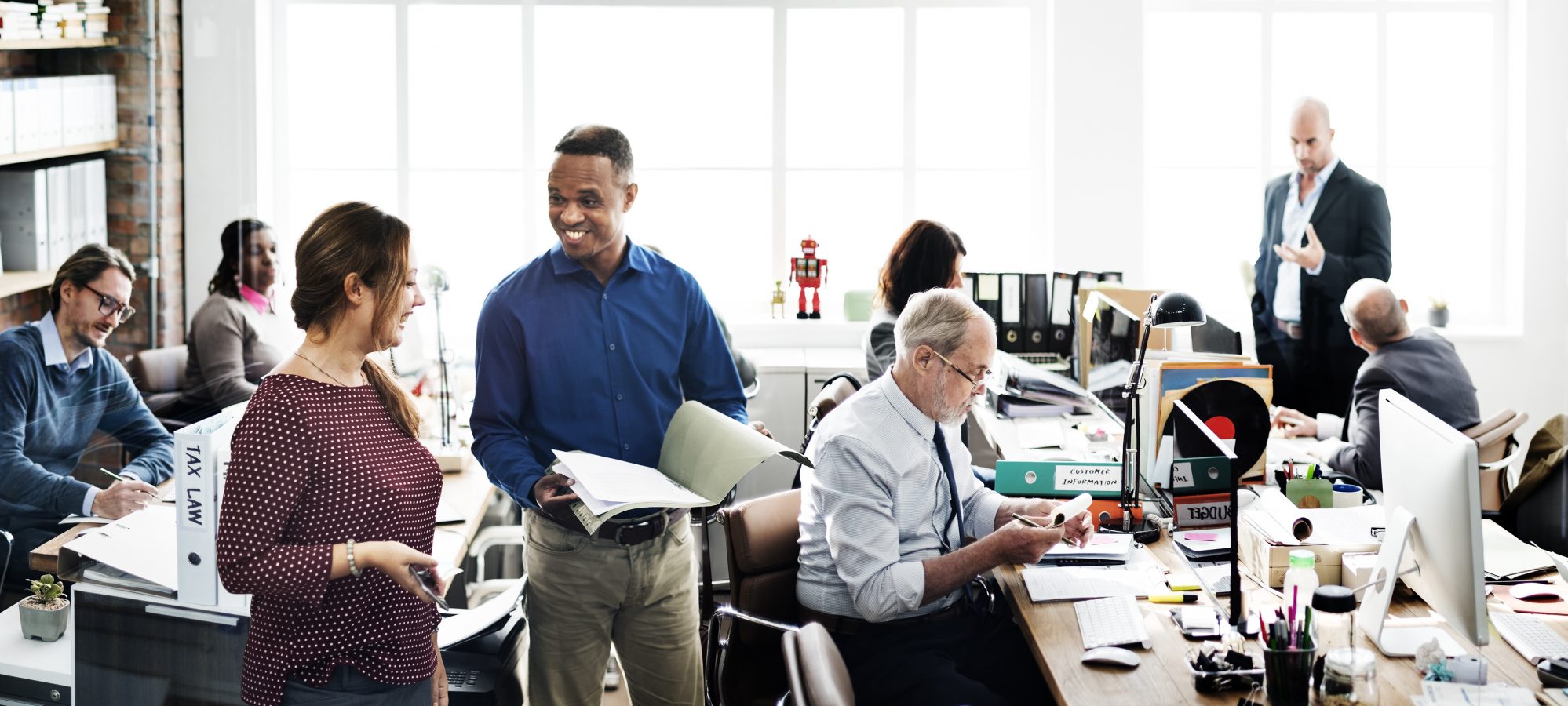 Image of business team working in open office and reviewing business' internal controls