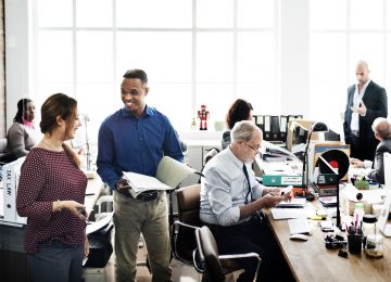 Image of business team working in open office and reviewing business' internal controls