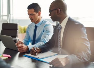 Two business executives in meeting and discussing the value of their business