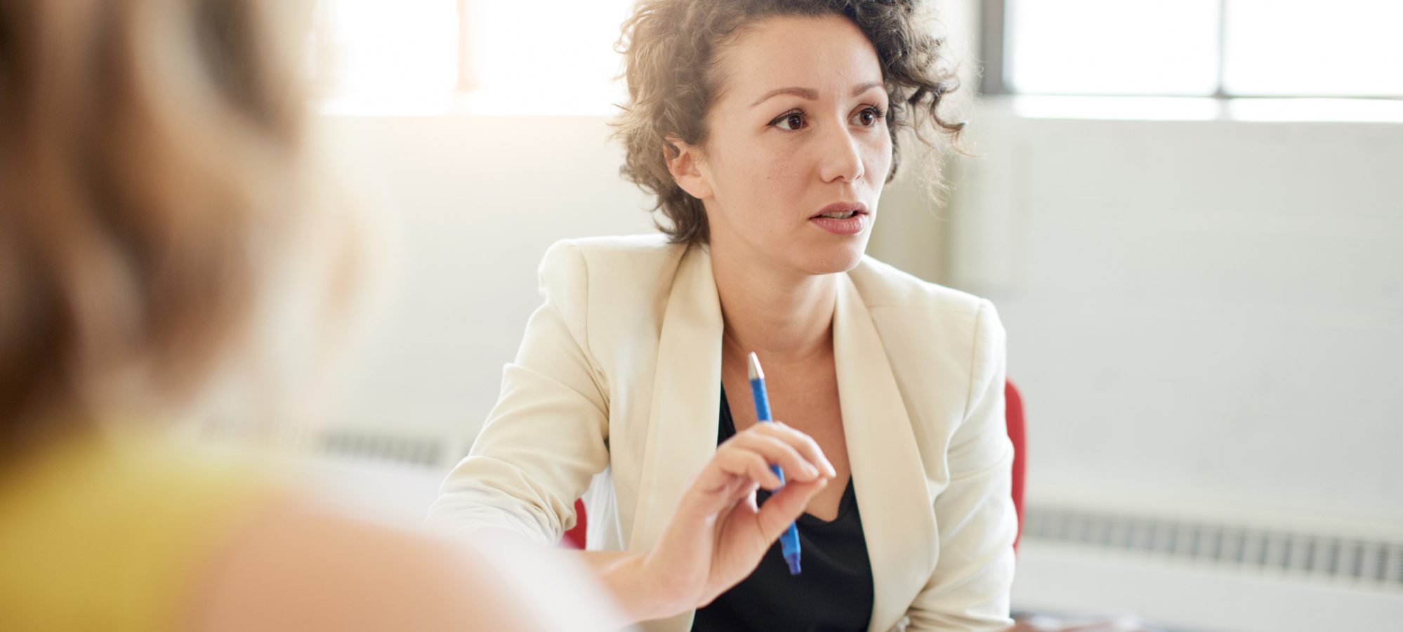 Female speaking to business team and discussing Michigan's paid medical leave act