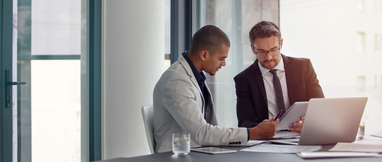 two business men discuss the payroll tax deferral in a meeting