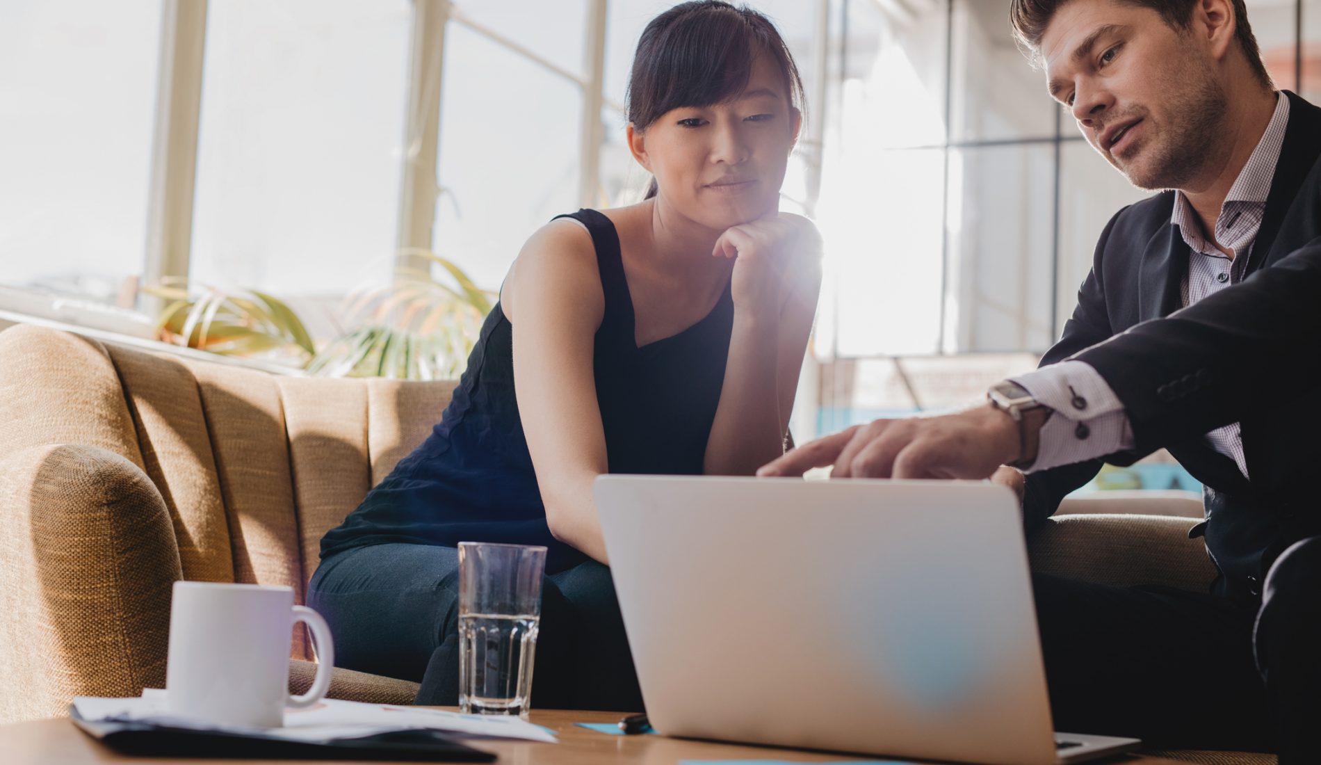 Image of a female business owner and valuation professional discussing the company's value