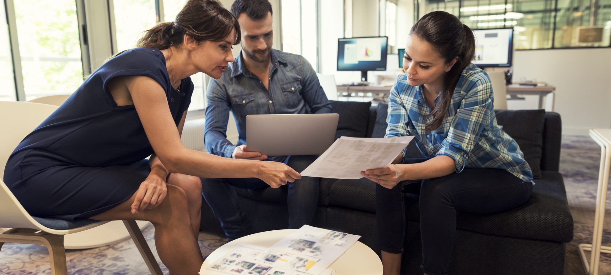 Image of management team meeting in open space to discuss sale of business