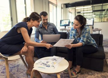 Image of management team meeting in open space to discuss sale of business