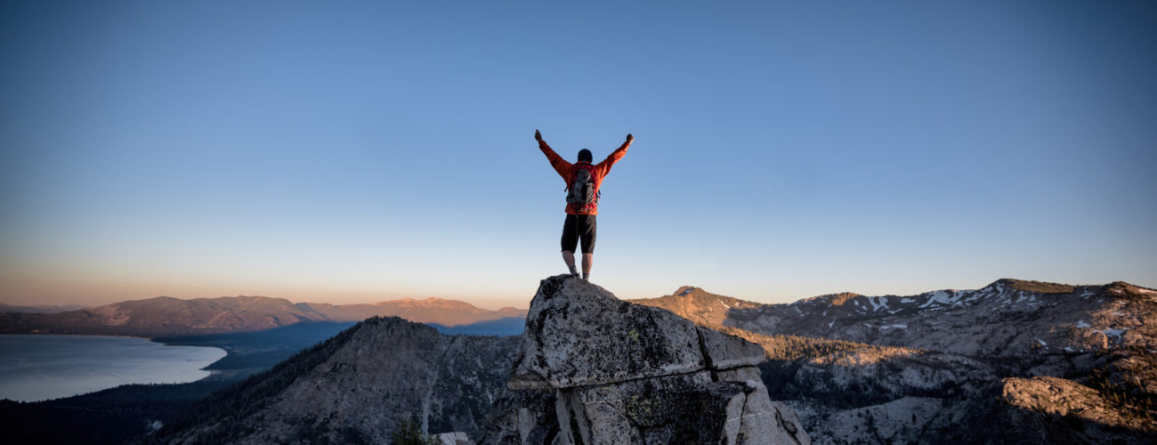 Climber reaches summit of mountain, represents nonprofits overcoming financial challenges