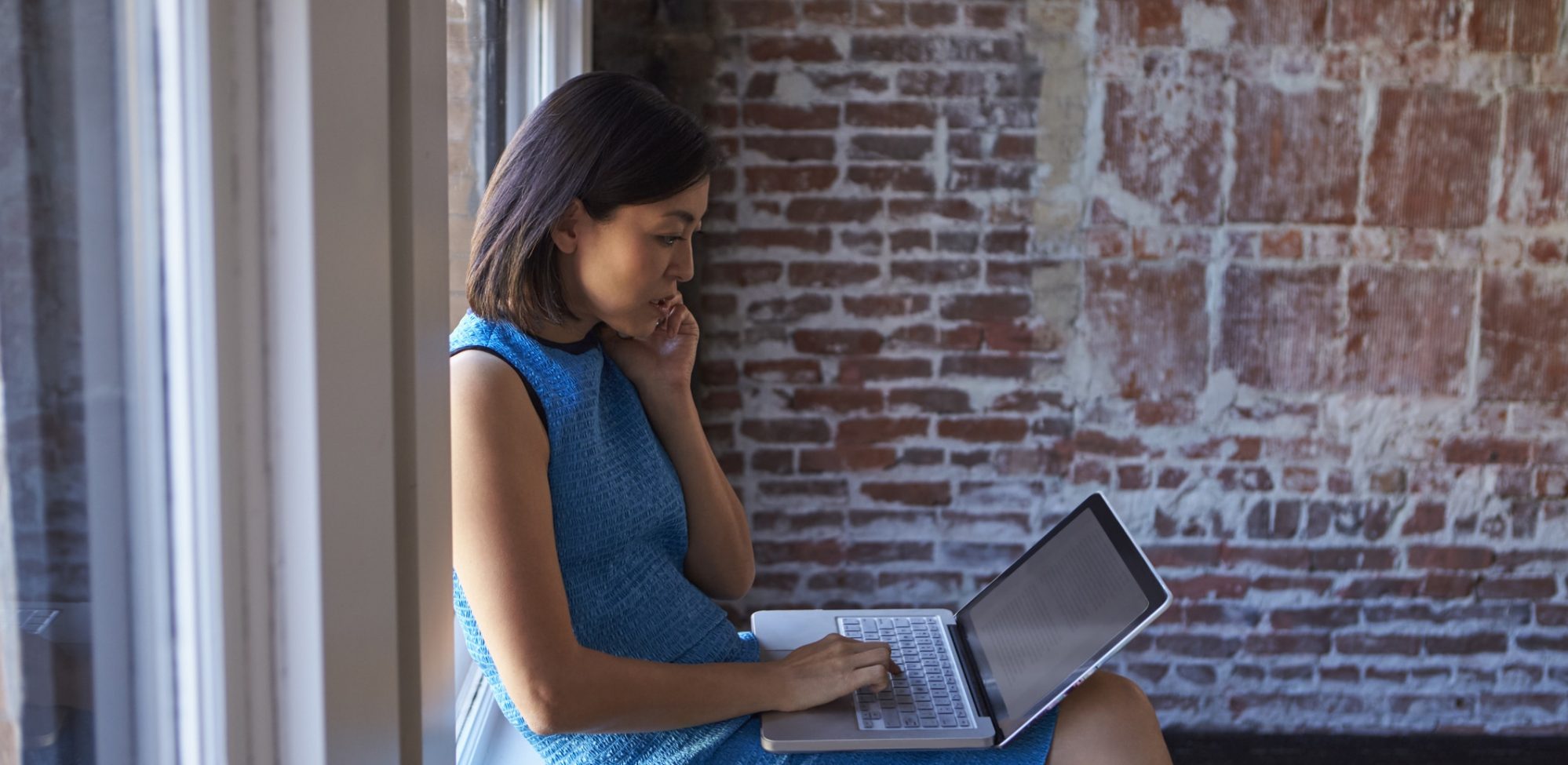 Business woman on laptop reviewing her nonprofit financial problems