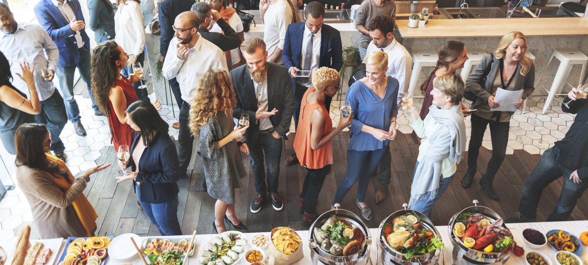 Image of business people networking and eating at company picnic