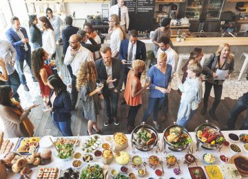 Image of business people networking and eating at company picnic