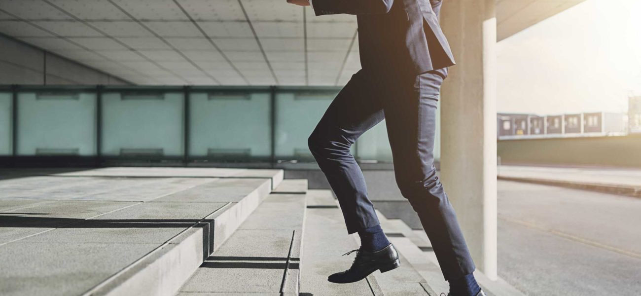 Businessman running up stairs