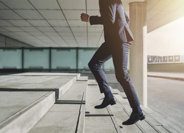 Businessman running up stairs