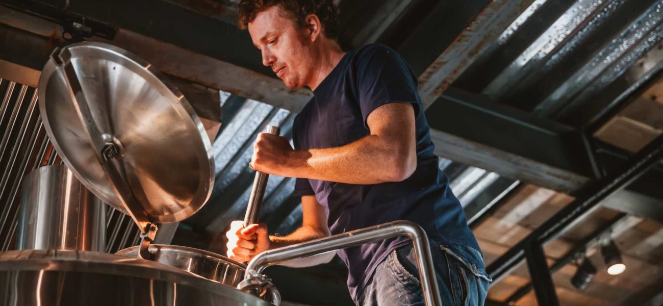 Image of owner of family owned business working in brewery