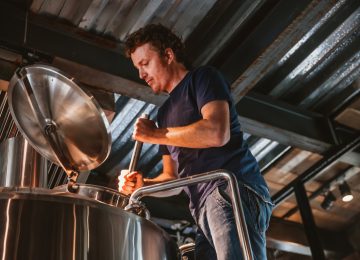 Image of owner of family owned business working in brewery