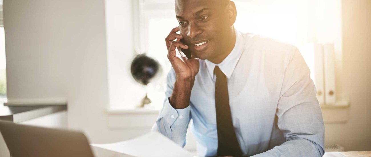 Image of young business professional talking on phone with accountant and discussing his SUW account