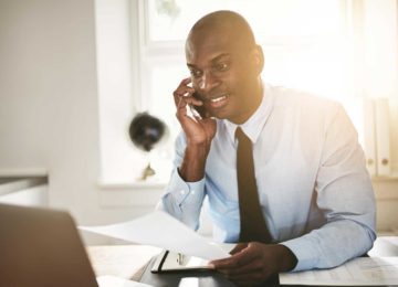 Image of young business professional talking on phone with accountant and discussing his SUW account