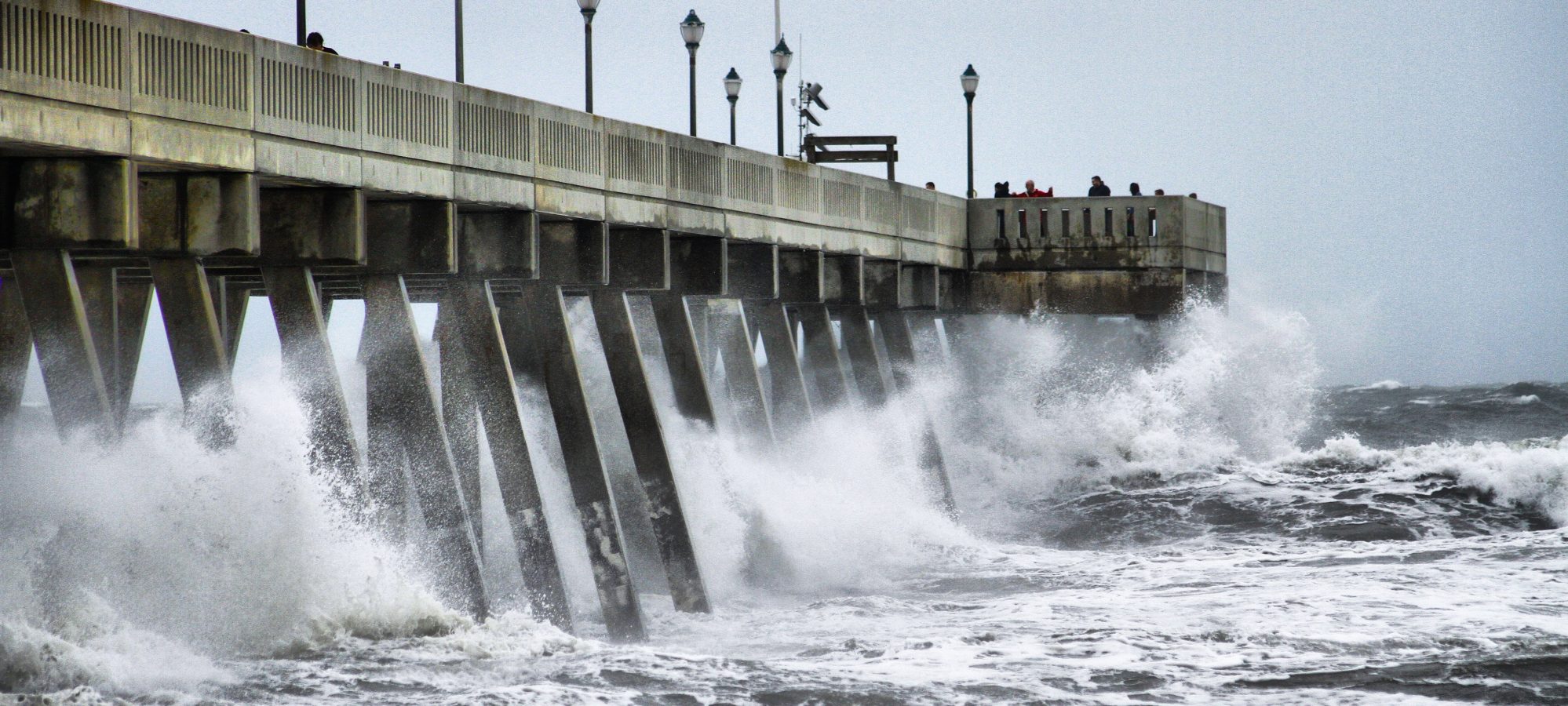 Image of storm surge from hurricane on pier - natural disaster