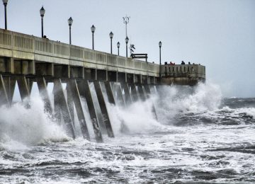 Image of storm surge from hurricane on pier - natural disaster