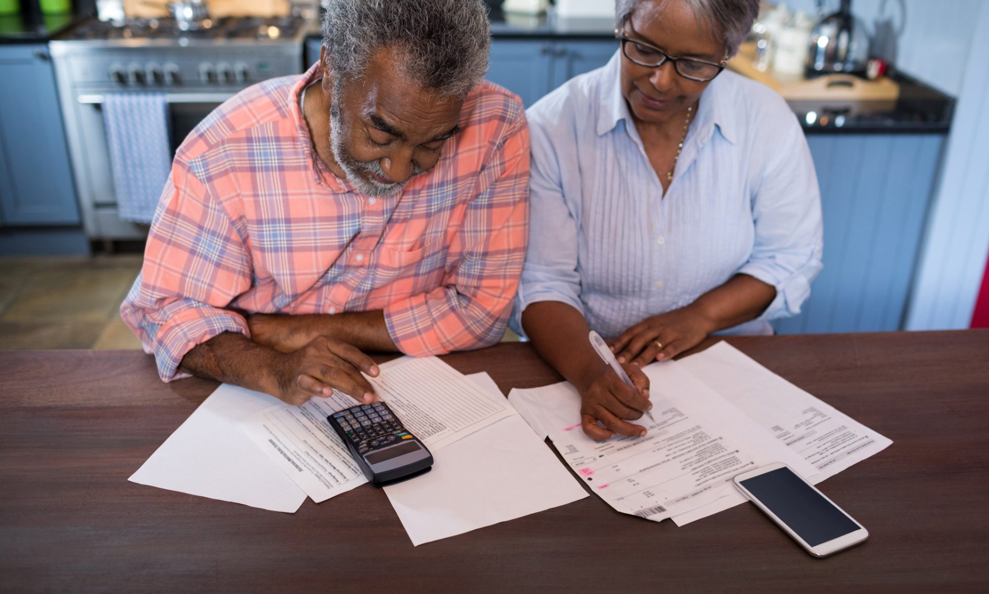 Image of couple reviewing their financial situation in kitchen at home