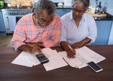 Image of couple reviewing their financial situation in kitchen at home