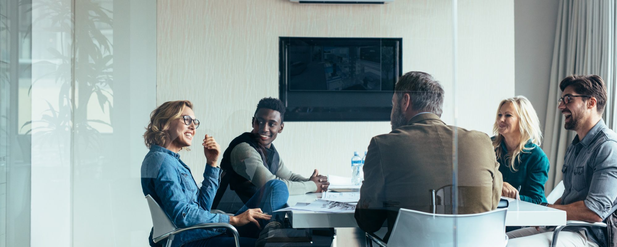 Image of business shareholders meeting in conference room and discussing the new partnership audit rules