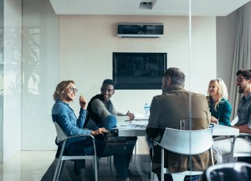 Image of business shareholders meeting in conference room and discussing the new partnership audit rules