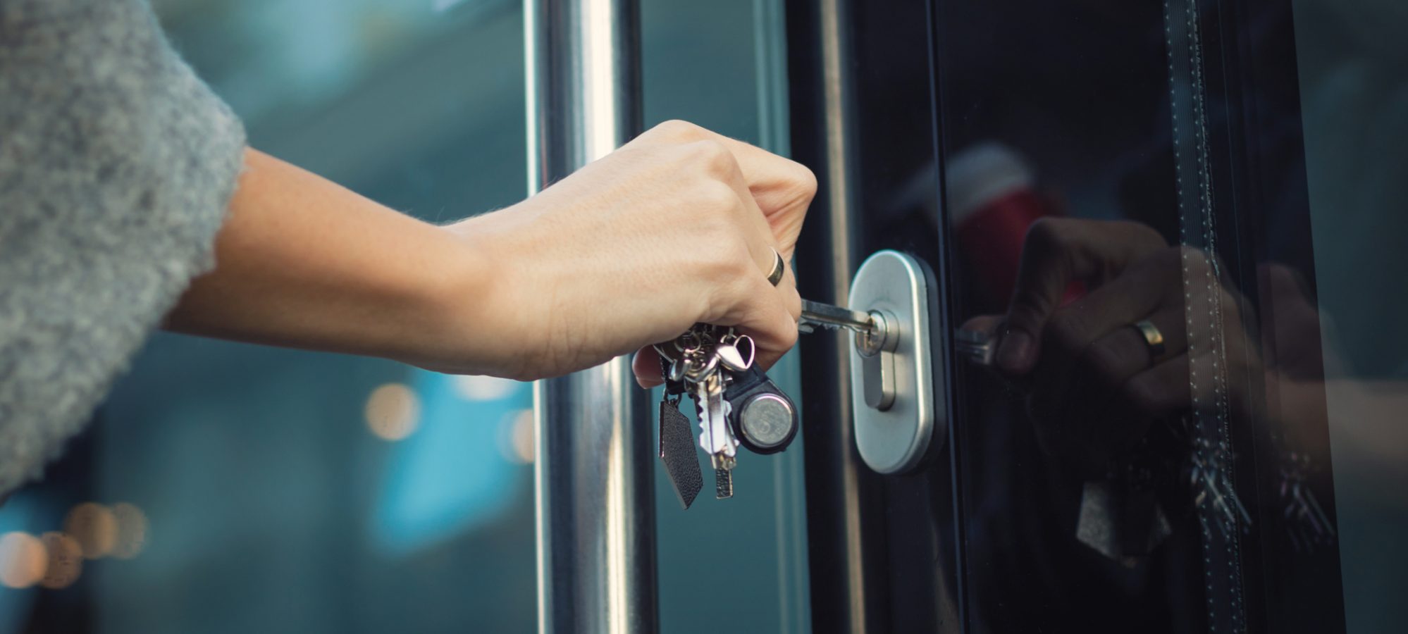 Image of woman locking door as way to prevent fraud in business