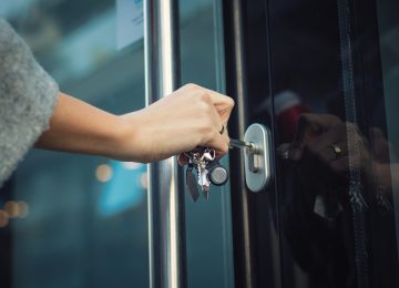 Image of woman locking door as way to prevent fraud in business