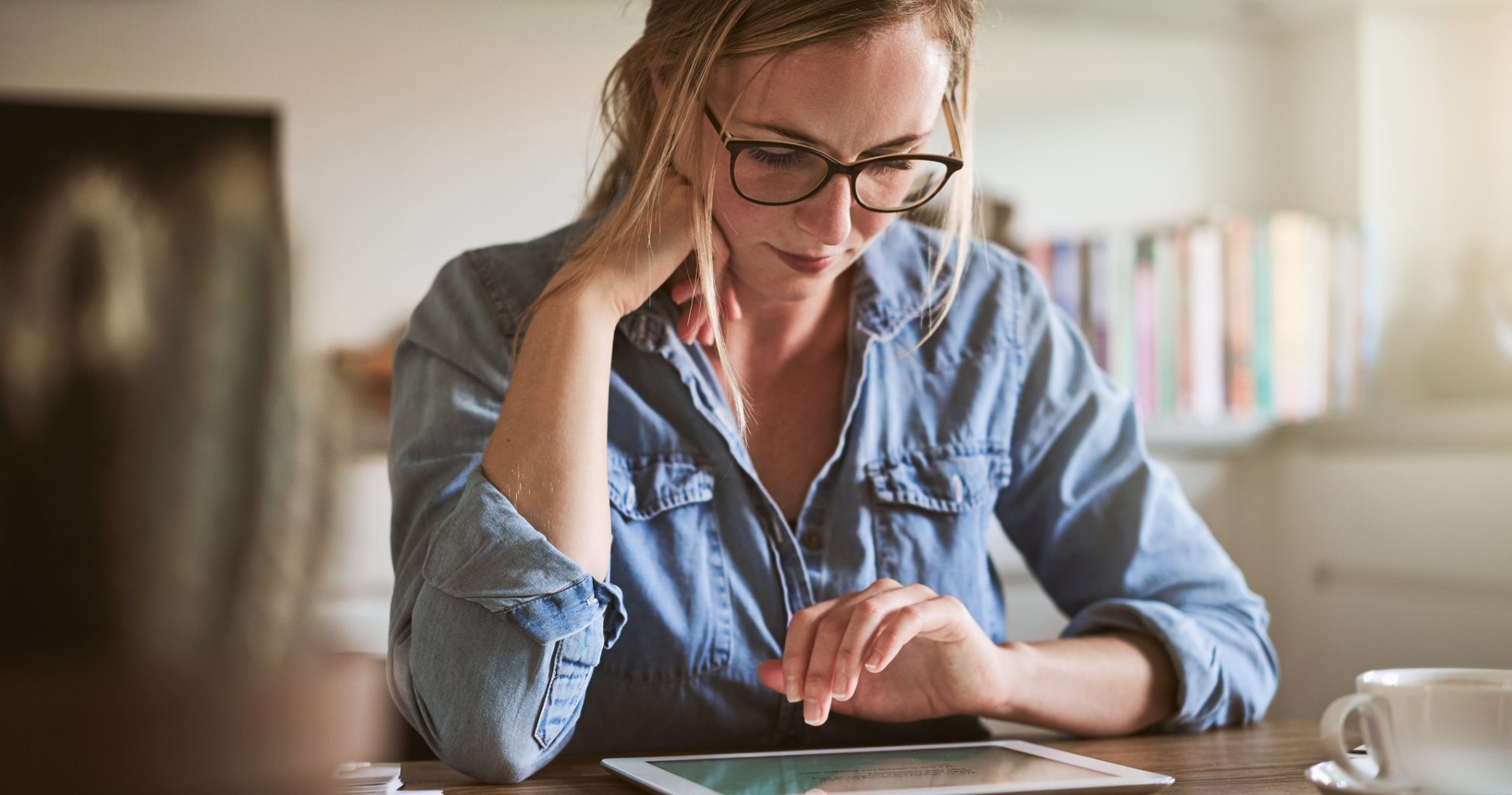 Image of young woman filing extension for her taxes on a tablet